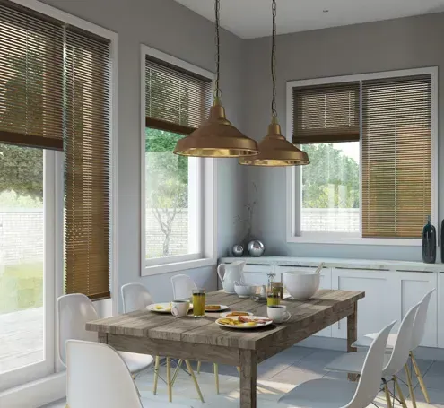 A dining room with a wooden table and white chairs