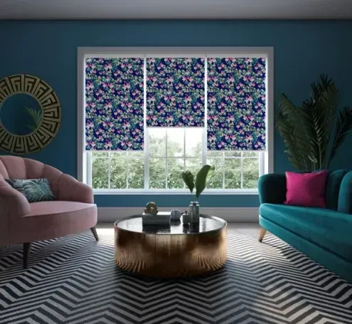 A living room with a couch , chair , coffee table and window.