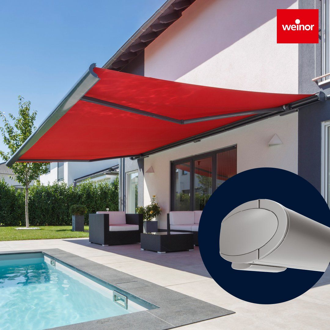 A house with a red awning over a swimming pool