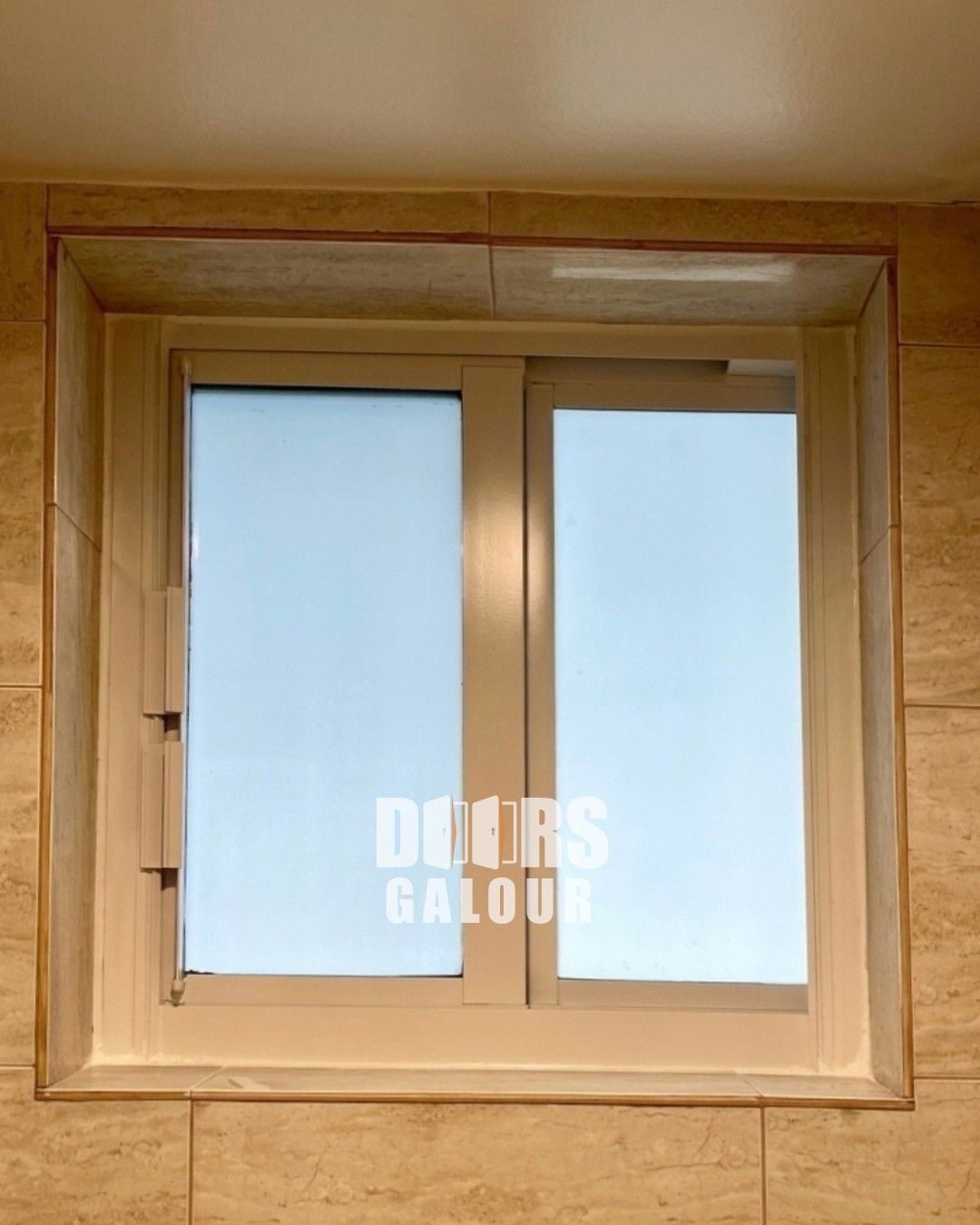 Newly installed window in a concrete wall, with unfinished stucco surrounding it.