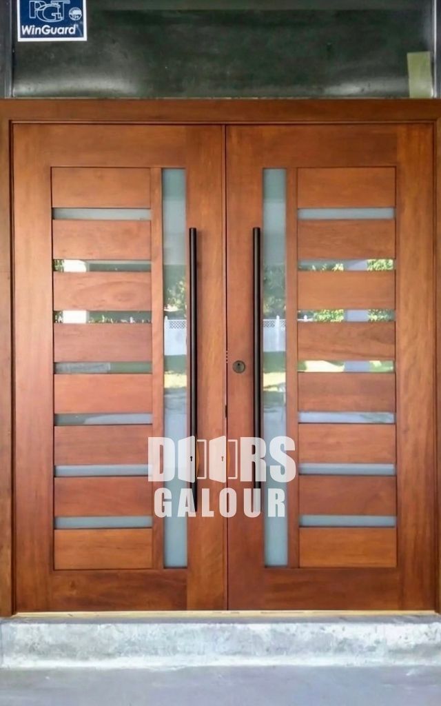 Gray double doors with glass panels and long silver handles.