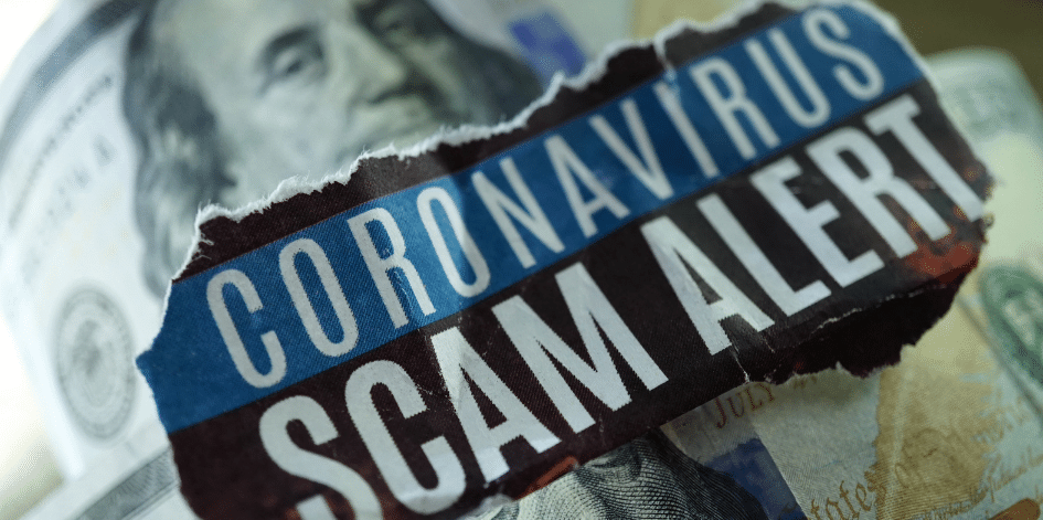 A piece of paper with the words `` coronavirus scam alert '' written on it is sitting on top of a pile of money.