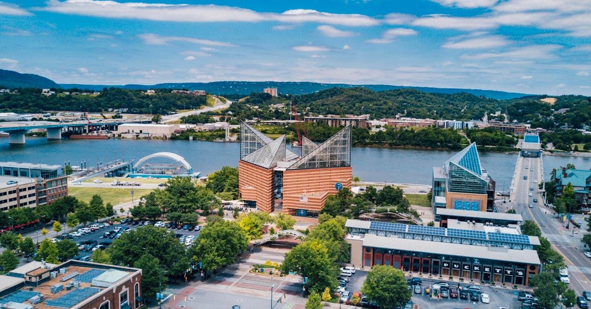 An aerial view of a city with a river in the background.