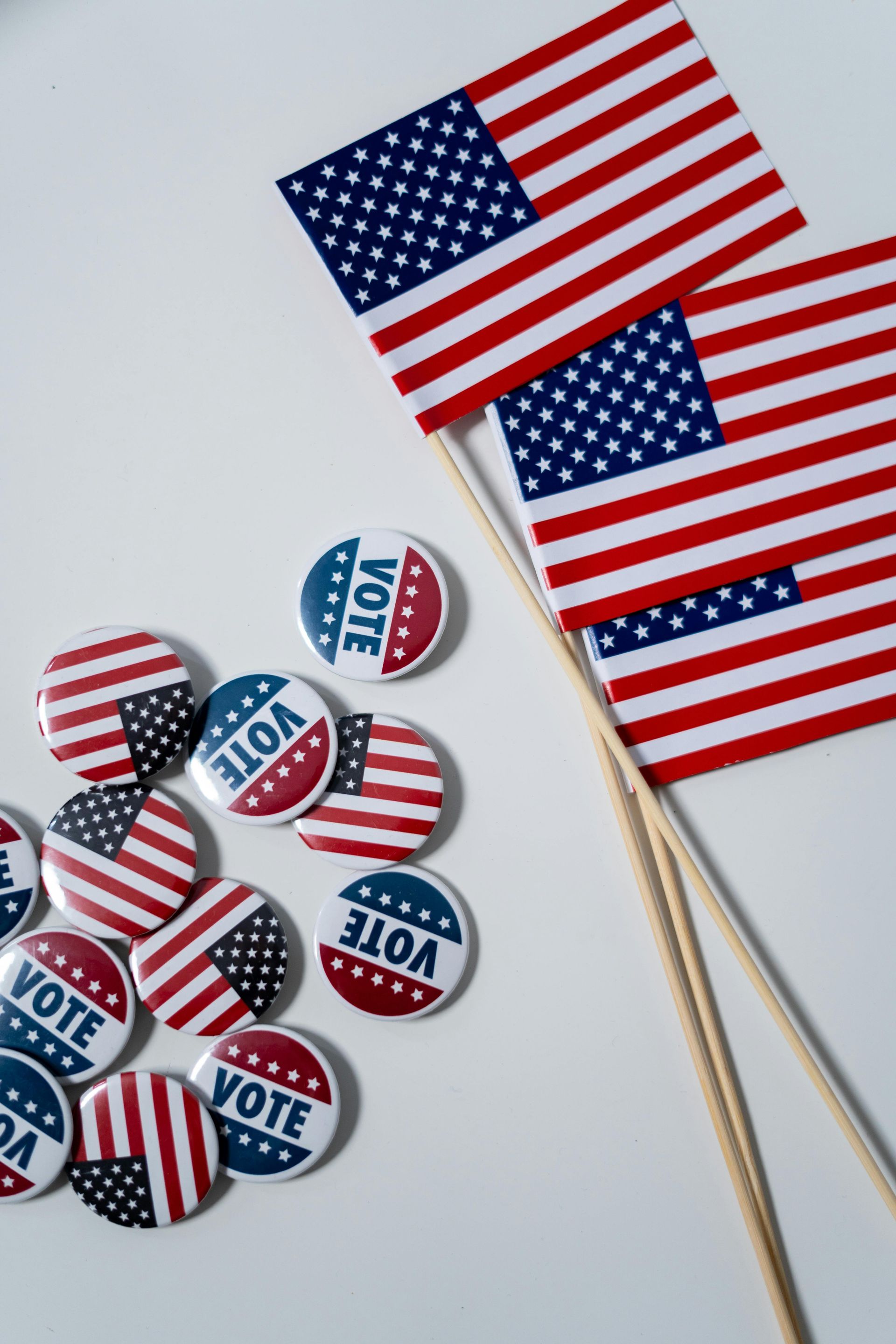 A bunch of american flags and buttons with the word vote on them