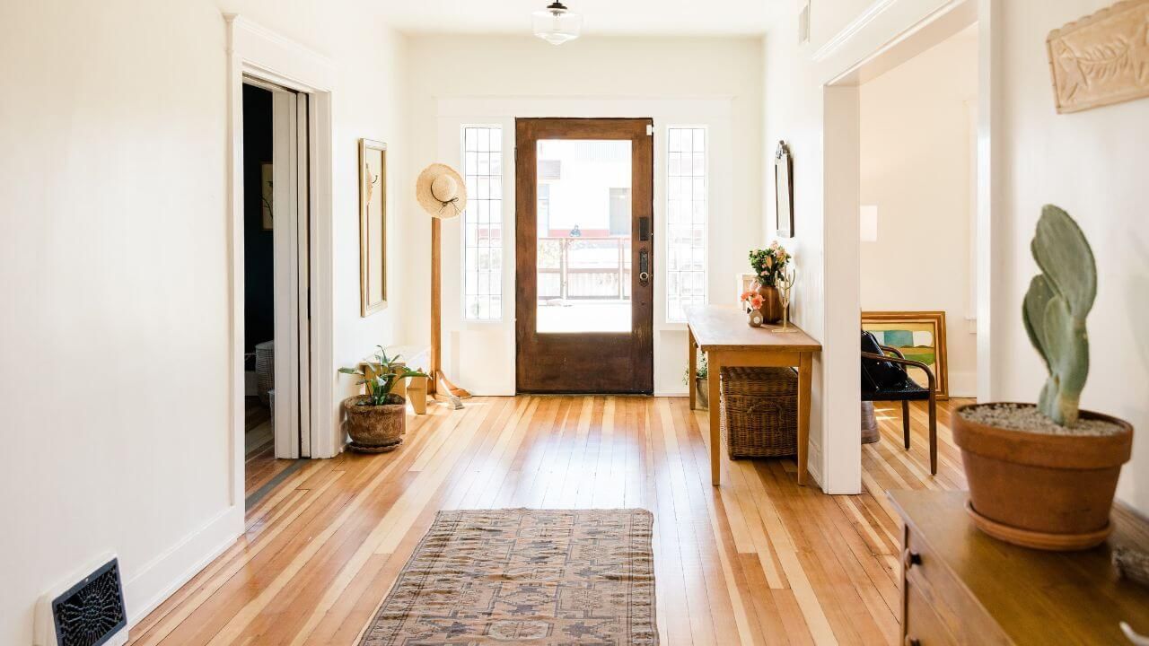 A wooden floor hallway with a closed door.