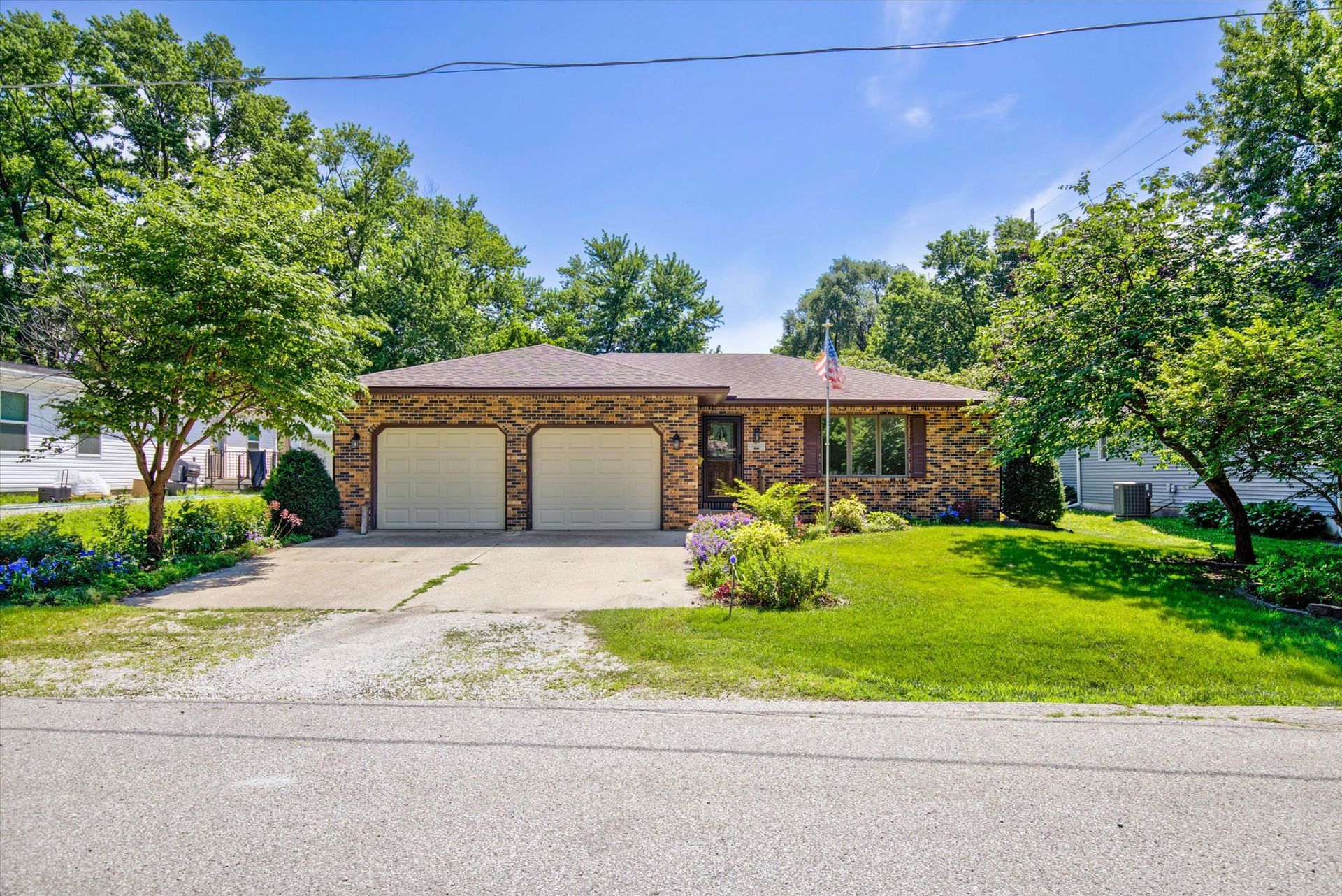 Brick ranch home in Nevada, IA offering a bonus 2-stall detached garage! 