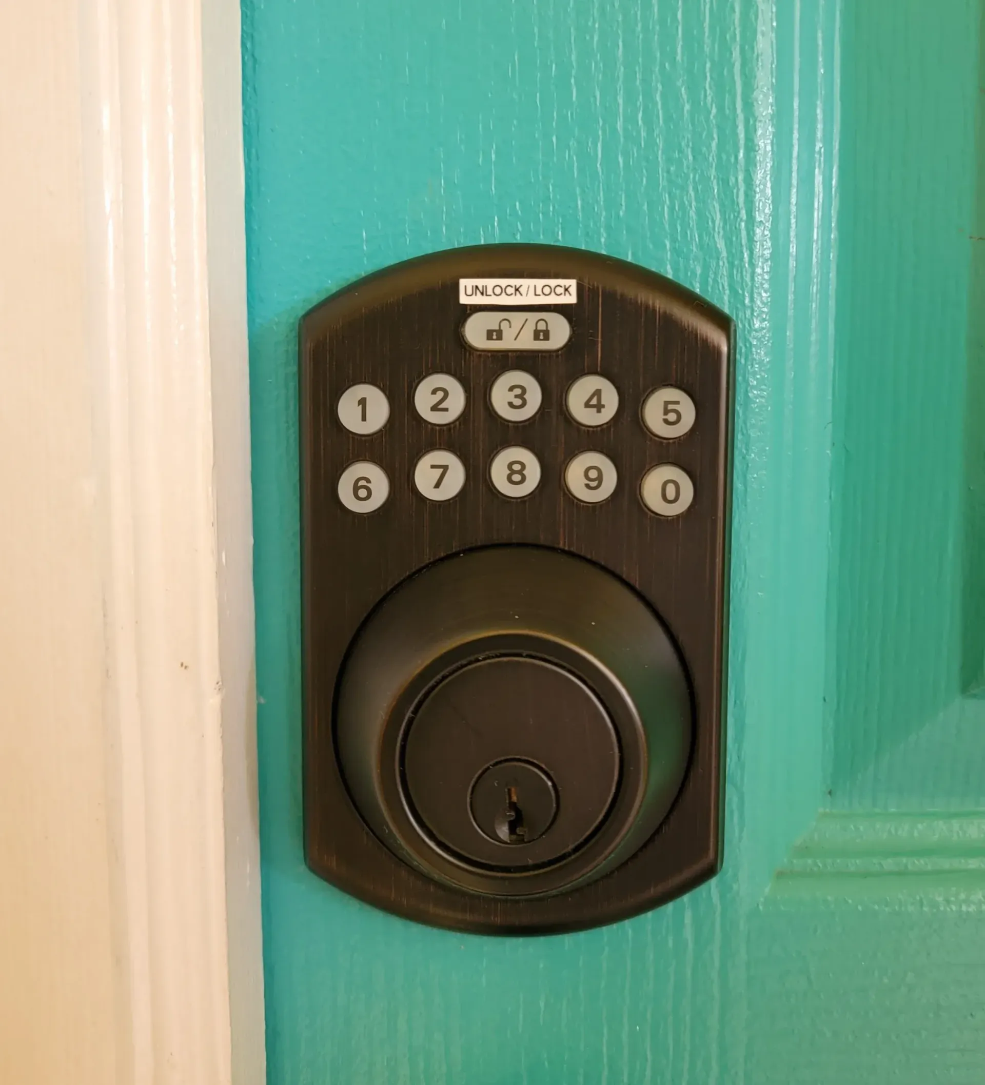 A close up of a digital door lock on a blue door.