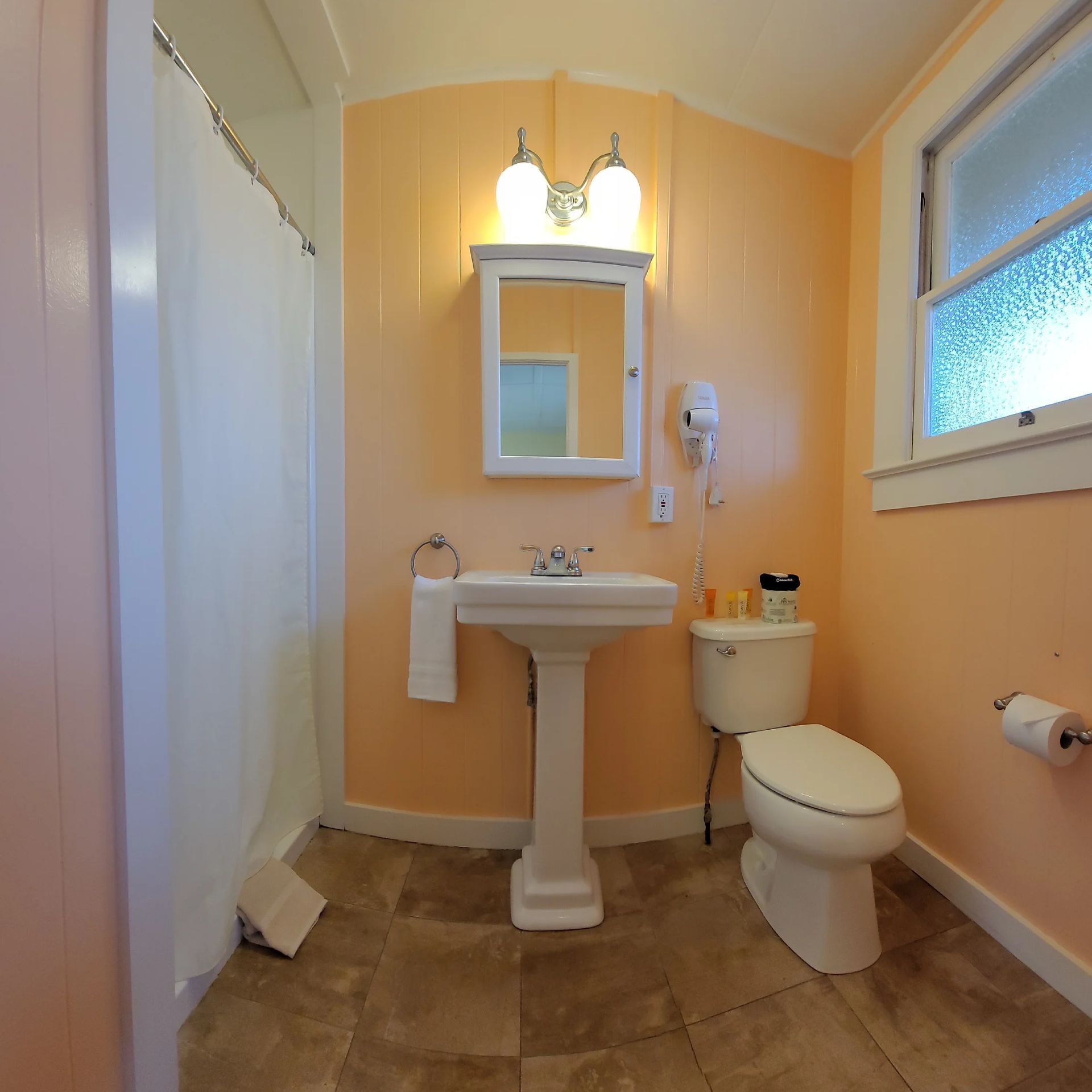 A bathroom with a sink toilet and mirror