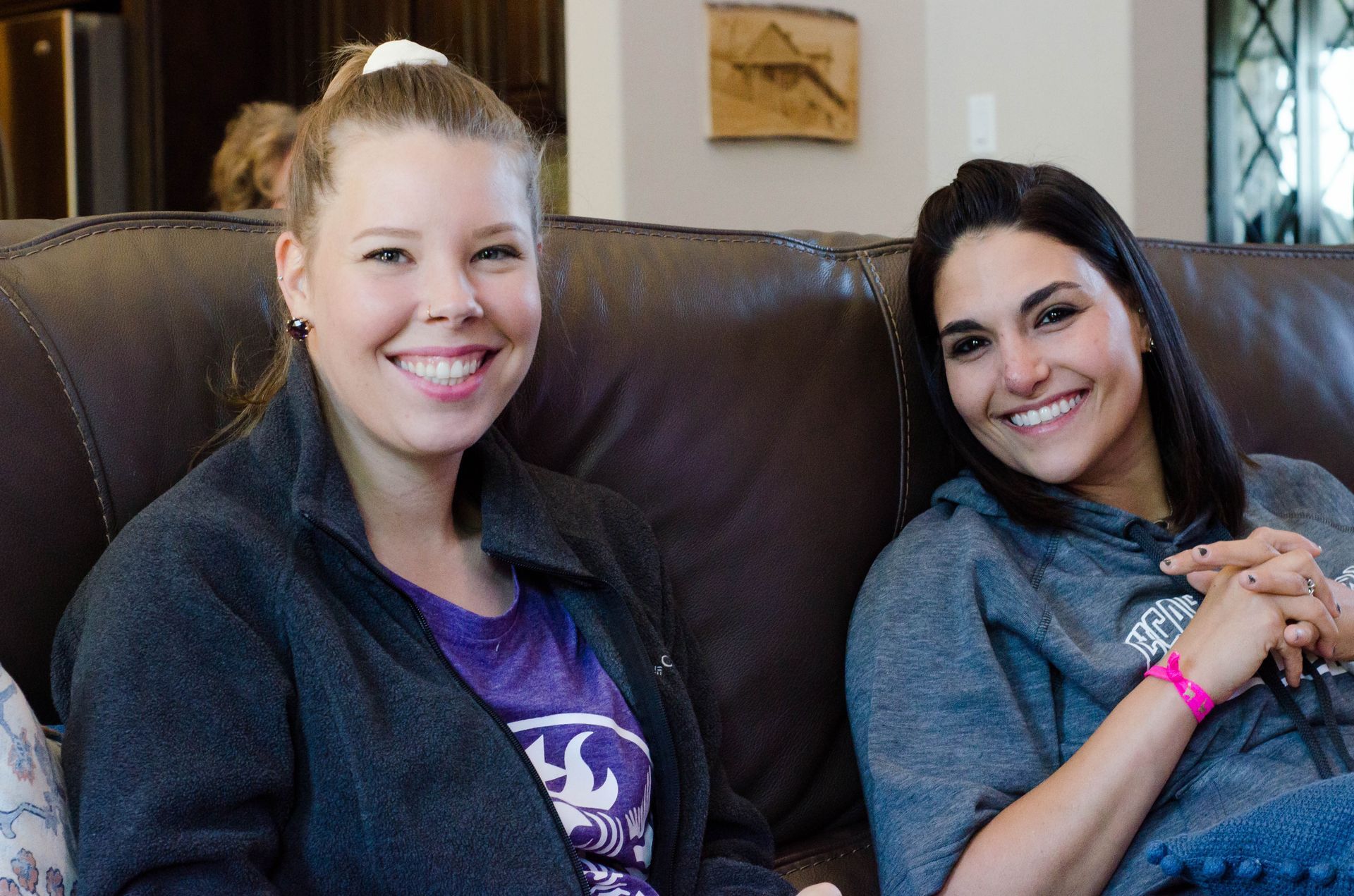 2 women from the citipointe church impact group sitting on a couch and smiling at the camera