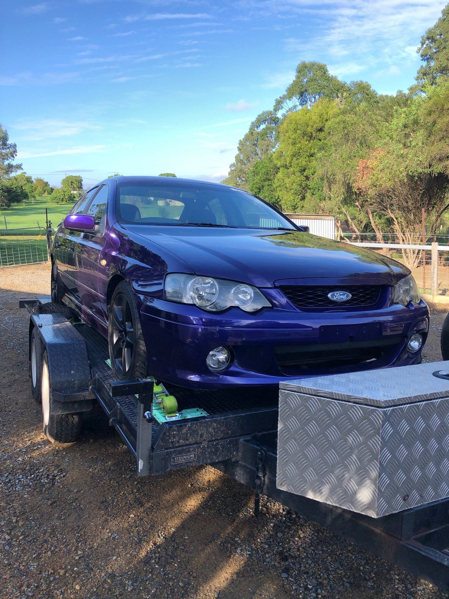 Purple Ford Car On Top Of The Trailer — Gympie Car Transport in Gympie, QLD