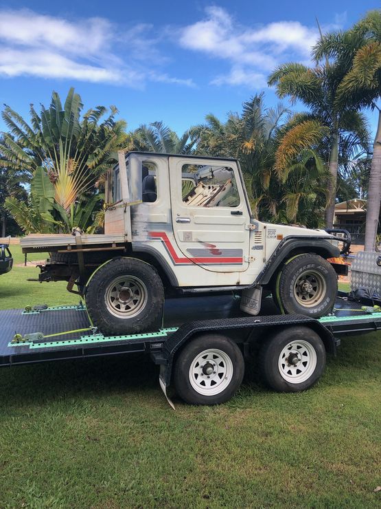 White Jeep Is Sitting On Top Of A Trailer — Gympie Car Transport in Gympie, QLD