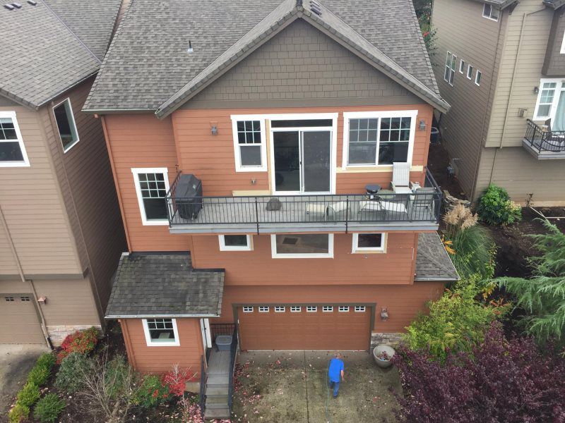 An aerial view of a large house with a balcony