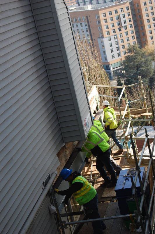 A group of construction workers are working on a building