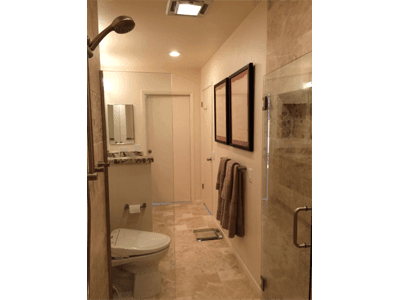 A bathroom with a toilet a sink and a shower