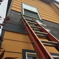 A ladder is attached to the side of a house.