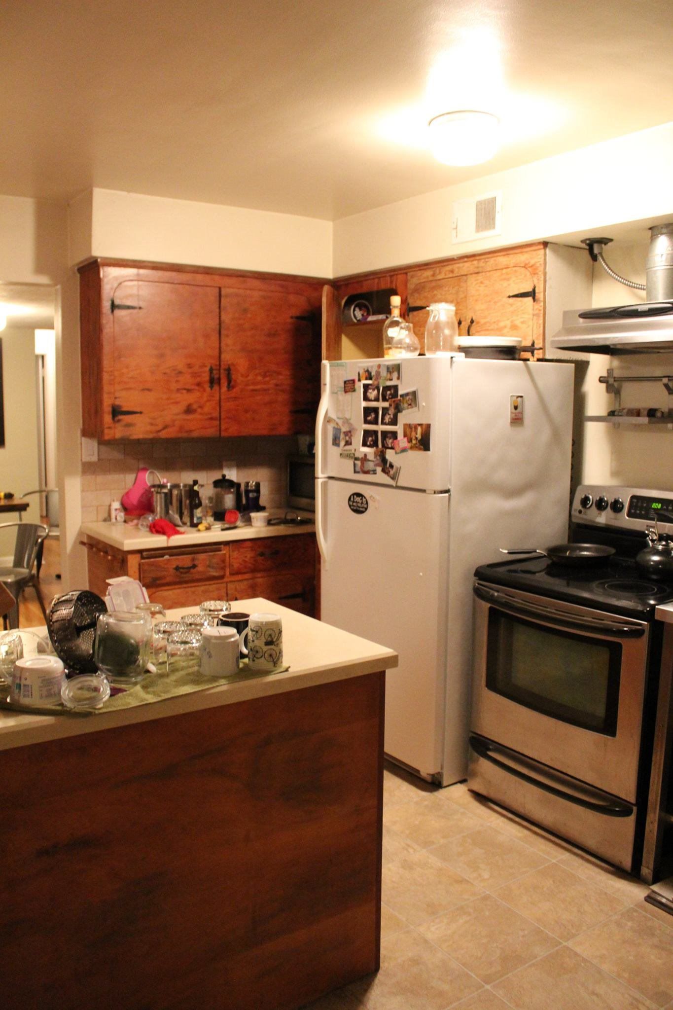 A kitchen with a refrigerator , stove , and sink.