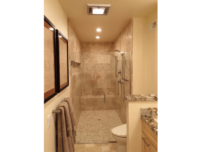 A bathroom with a walk in shower and a toilet