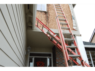 A ladder is attached to the side of a house