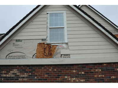 A house with a window that is missing siding