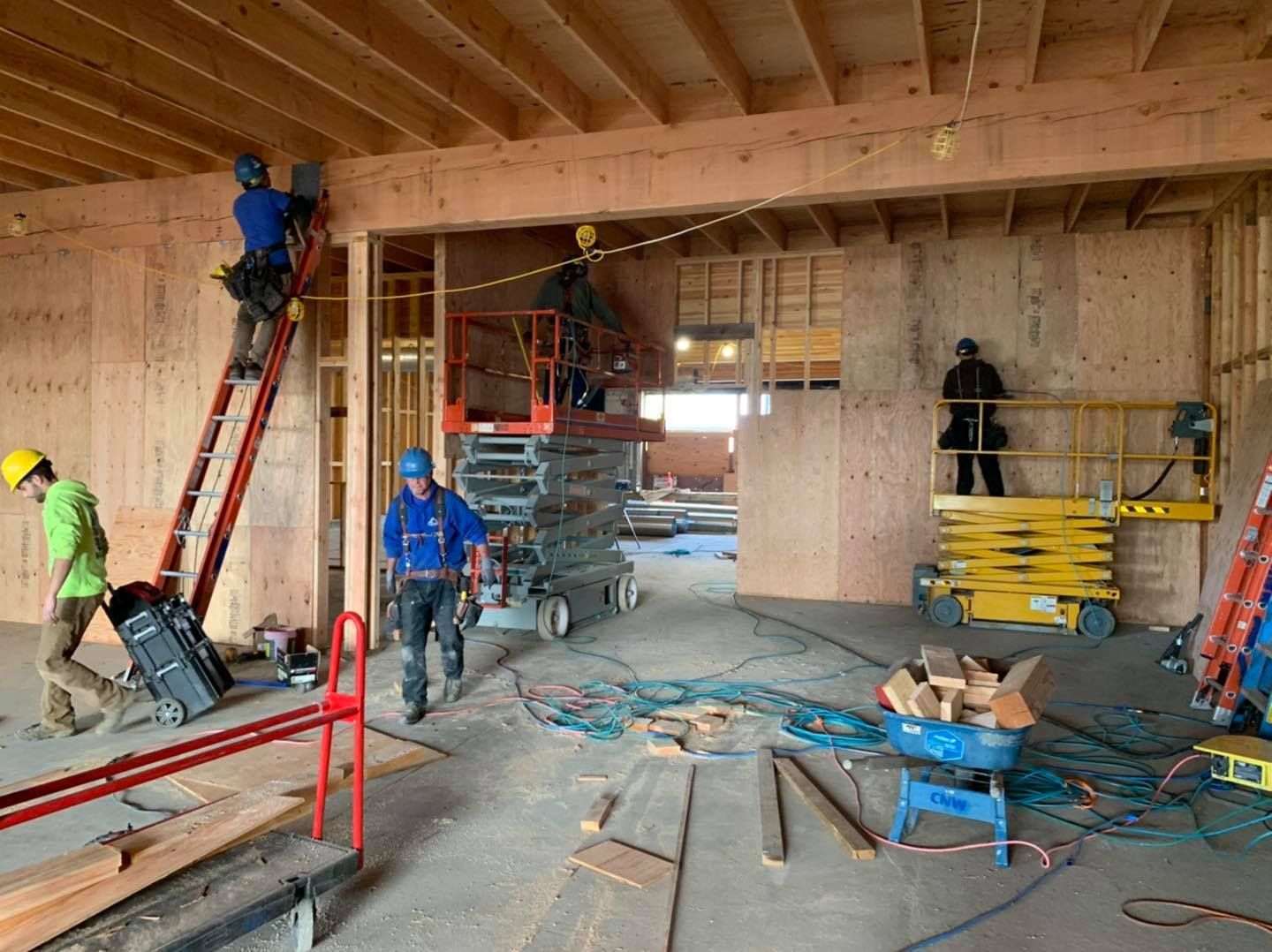 A group of construction workers are working on a building under construction.