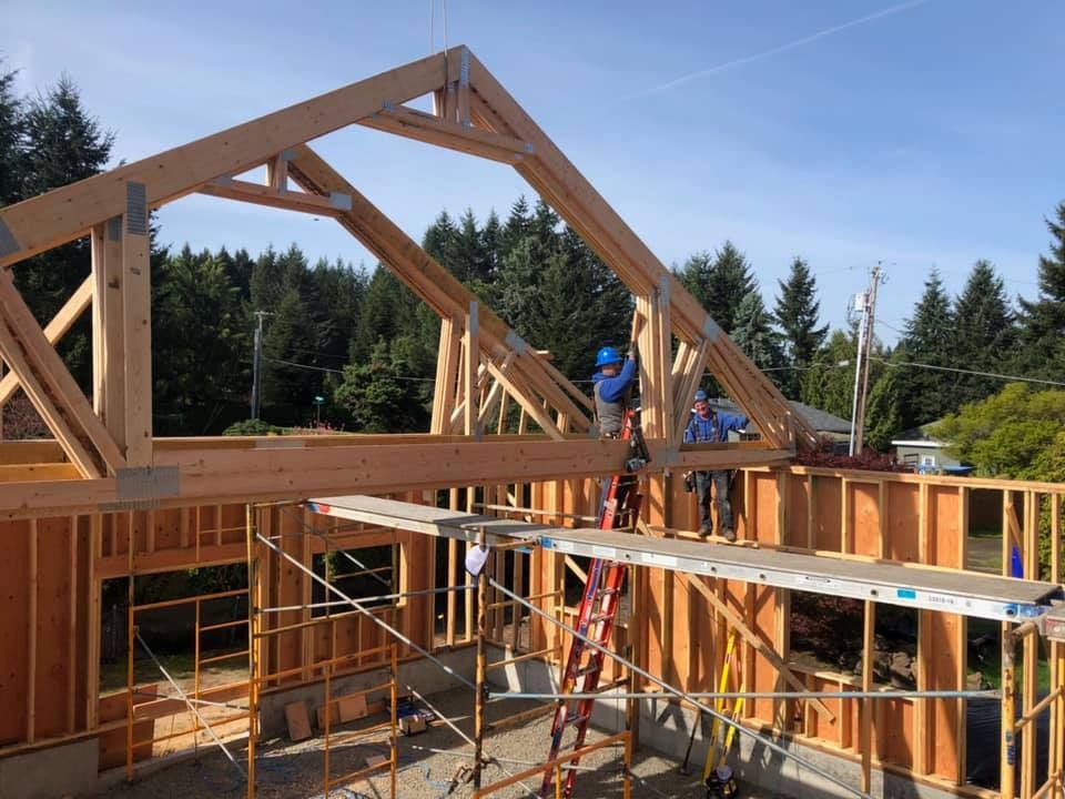 A group of people are working on a wooden structure.