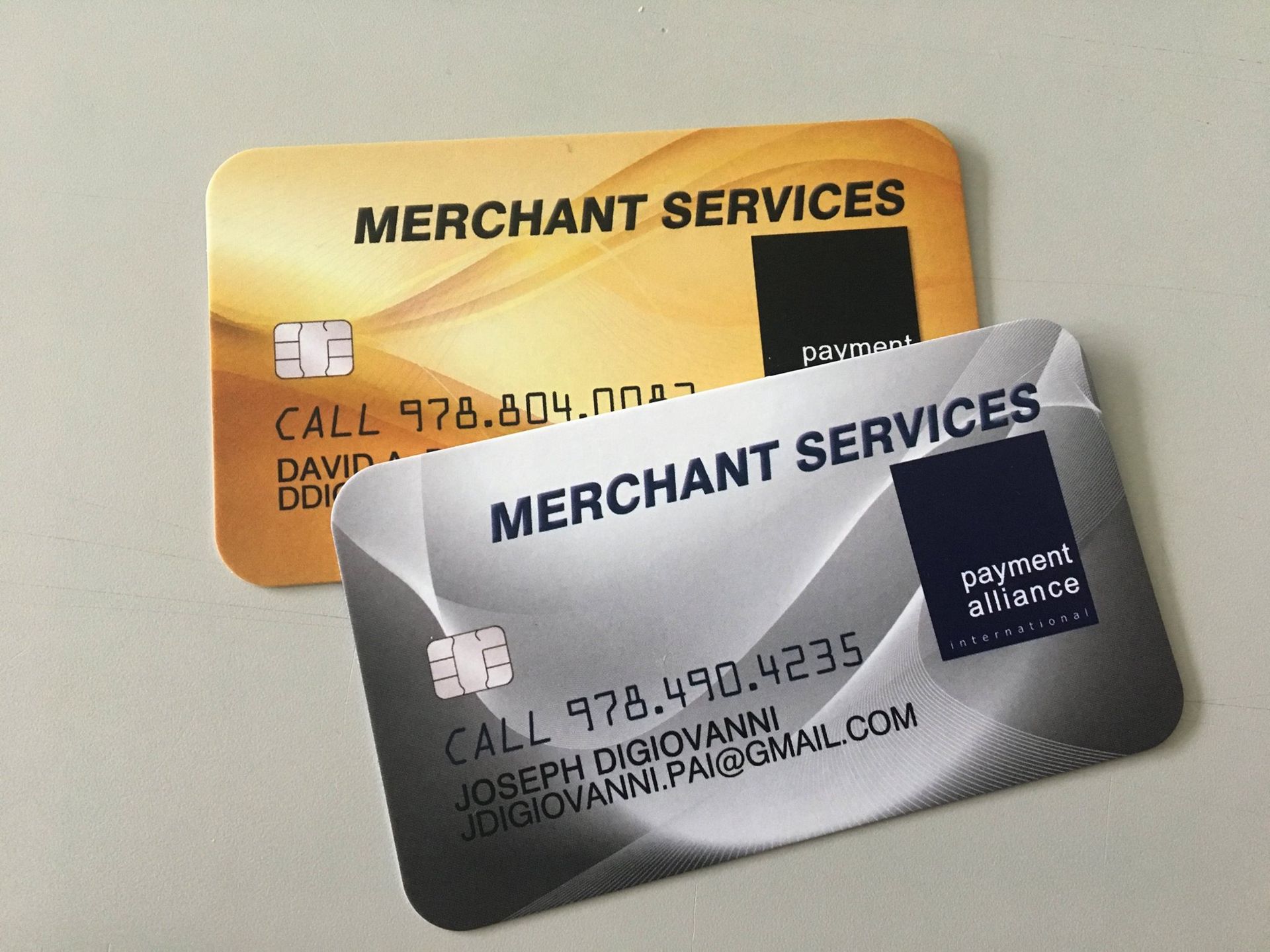 A gold merchant services card and a silver merchant services card