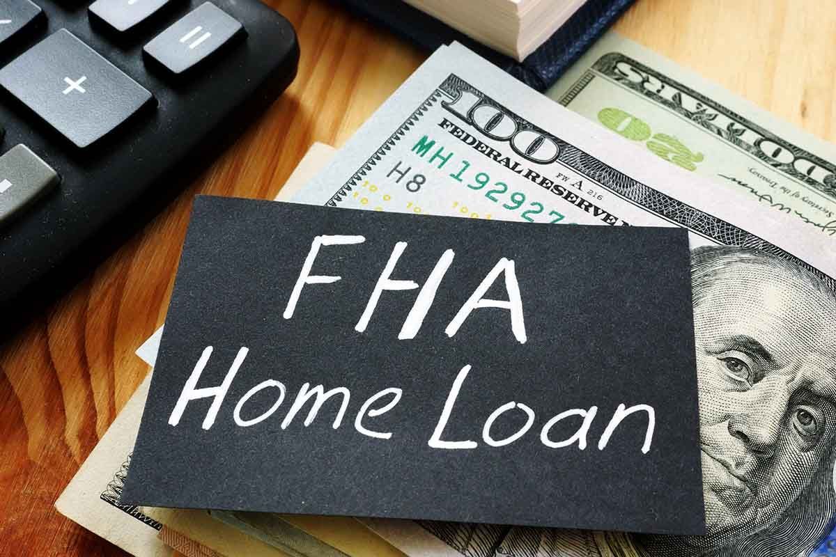 FHA home loan concept with cash and a calculator in the background