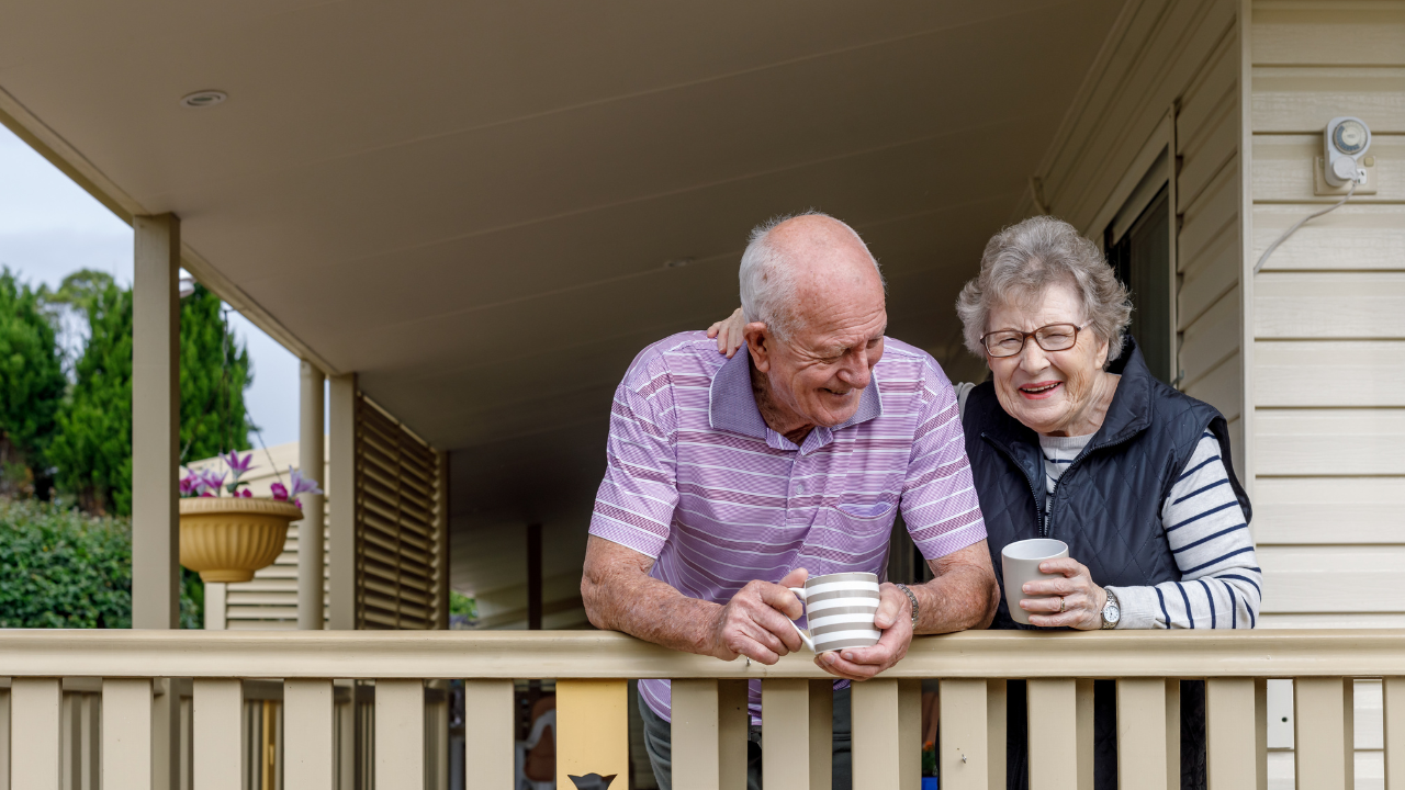 baby boomer couple enjoying coffee on the porch