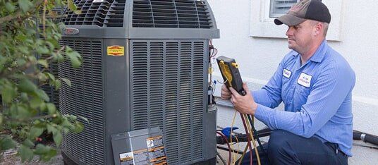 An expert working on an HVAC system for a company that does heating repair in Knoxville, TN