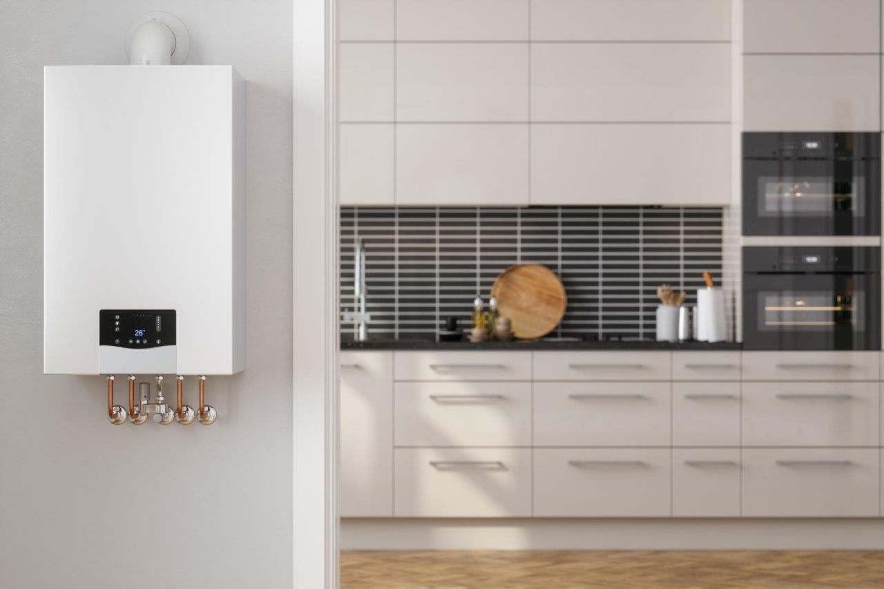 Una caldaia bianca è appesa a una parete accanto alla cucina.