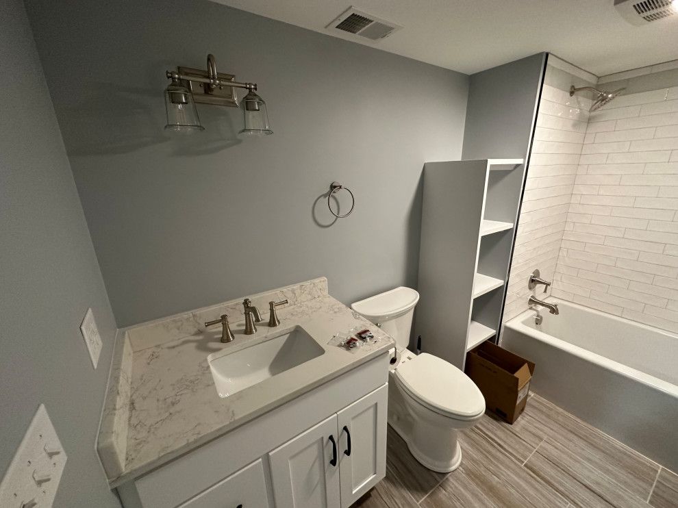 A bathroom with a sink , toilet , and bathtub.