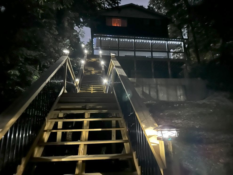 A set of stairs leading up to a house at night