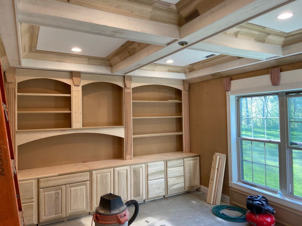 A room with a lot of shelves and cabinets and a window.