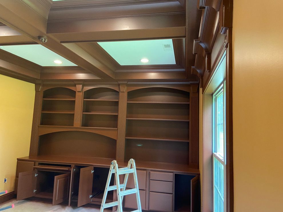 A room with a lot of shelves and a ladder