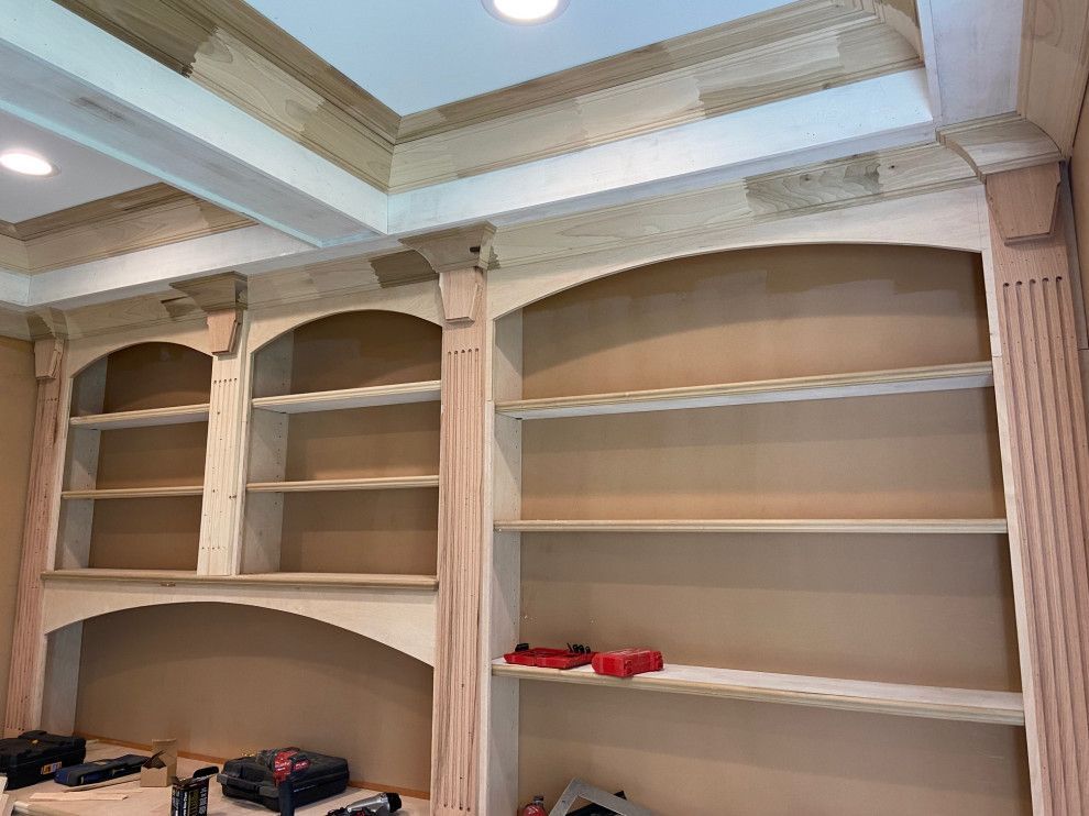 A room with a lot of shelves and a ceiling.