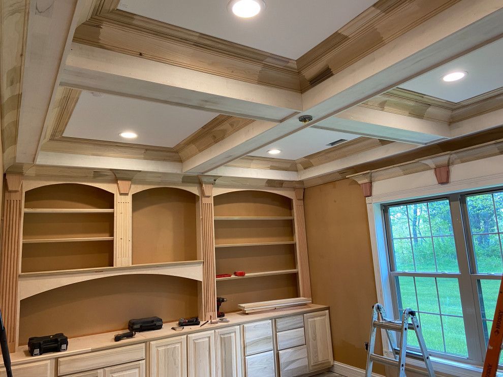 A room with a ladder and shelves in it is being remodeled.