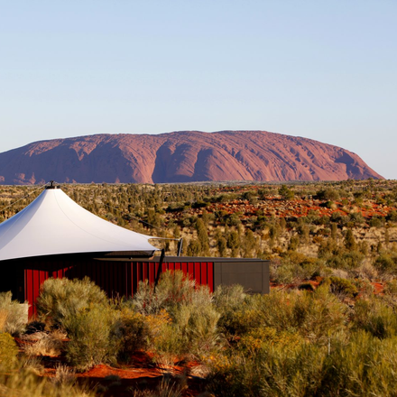 Longitude 131 in the desert with a Uluru in the background