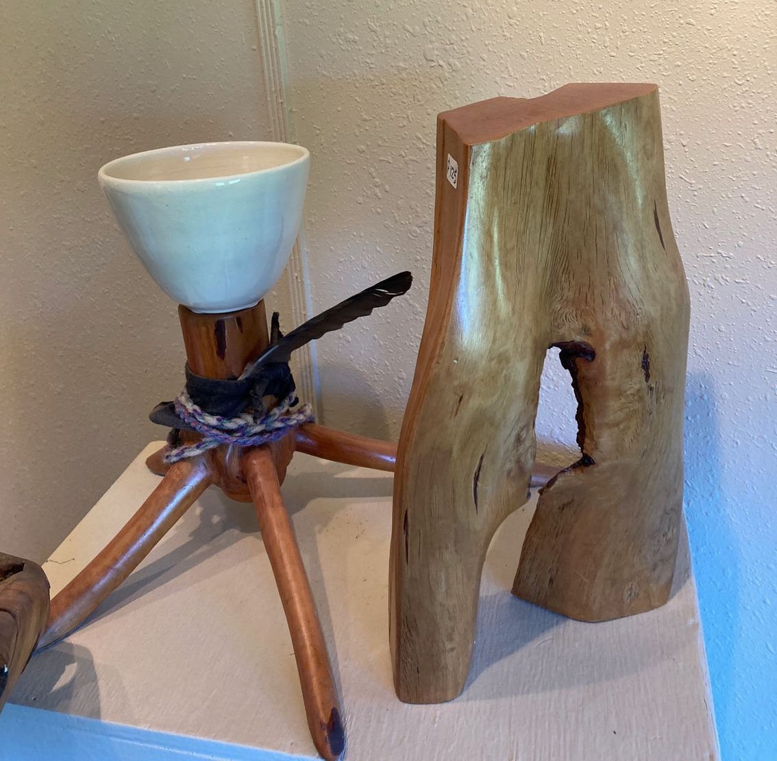 A wooden object with a hole in it is on a table