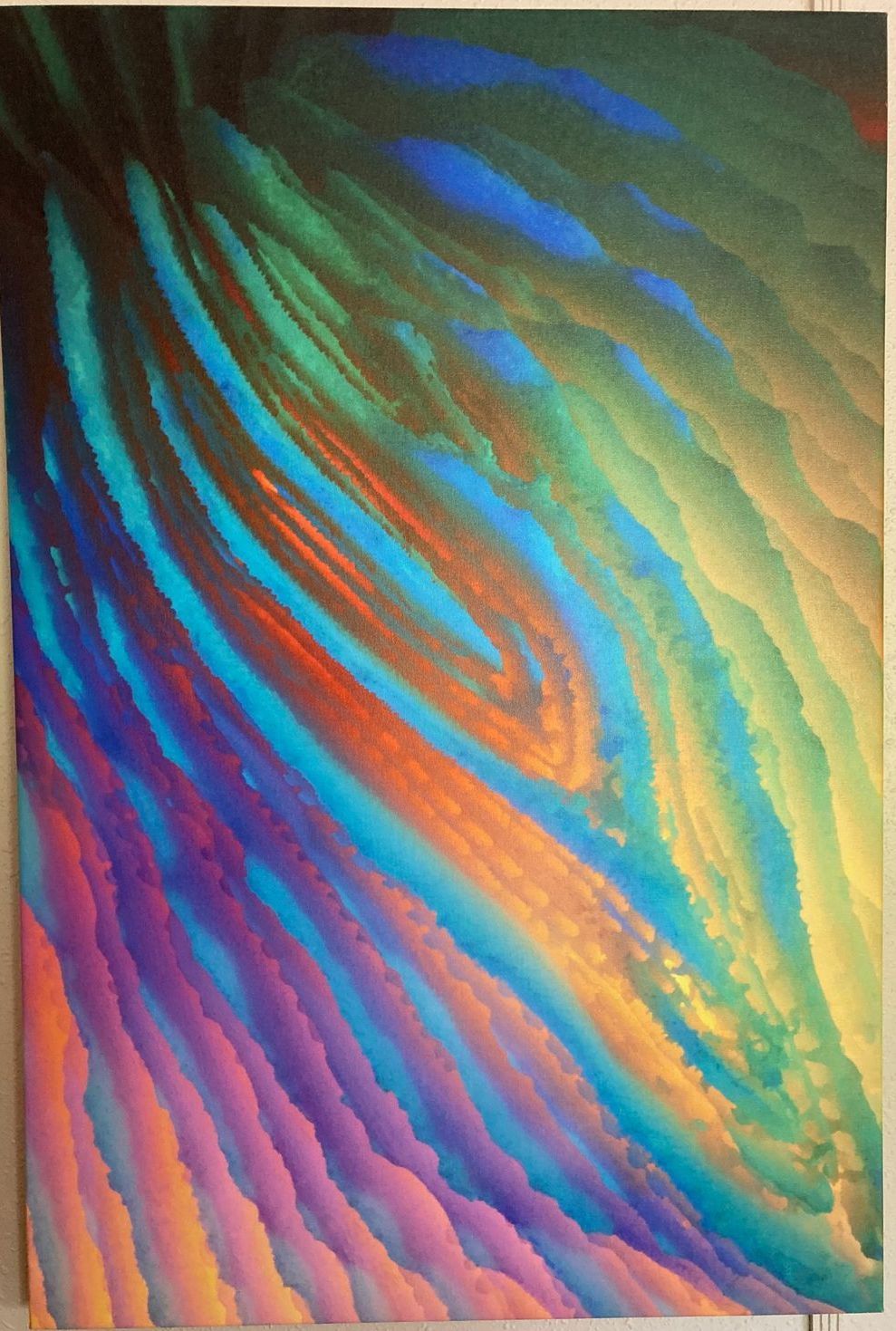 A colorful painting is hanging on a white wall.