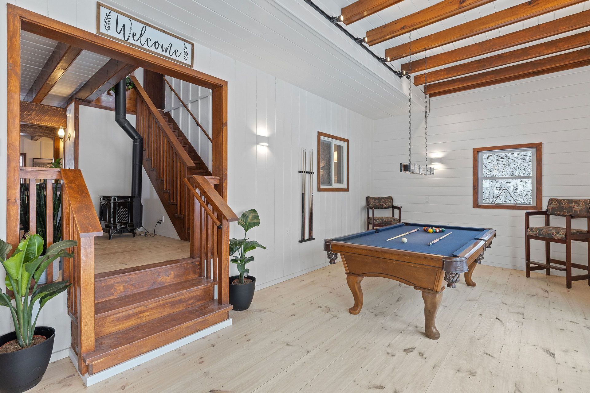There is a pool table in the middle of the room.