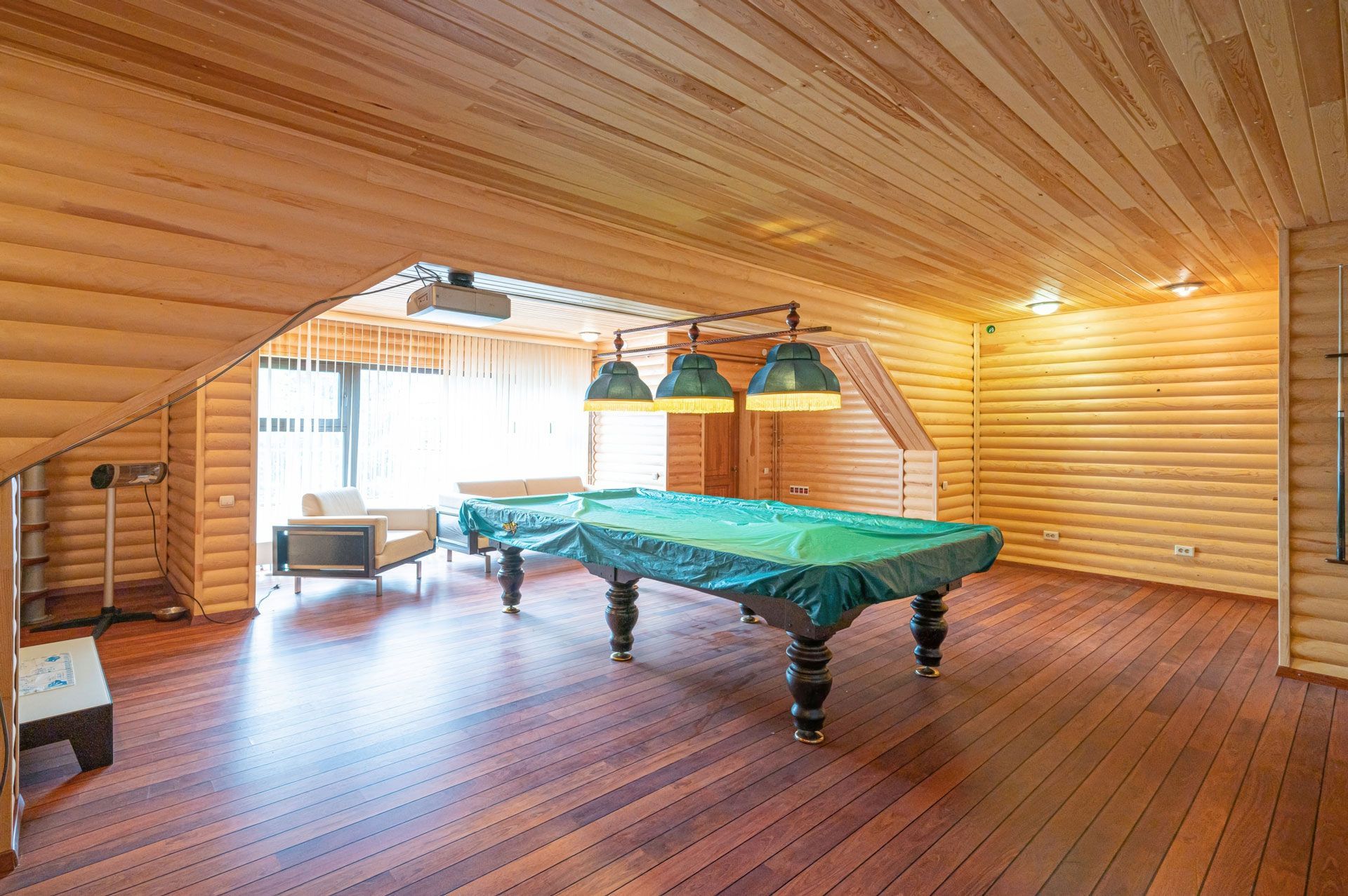 There is a pool table in the middle of the room.