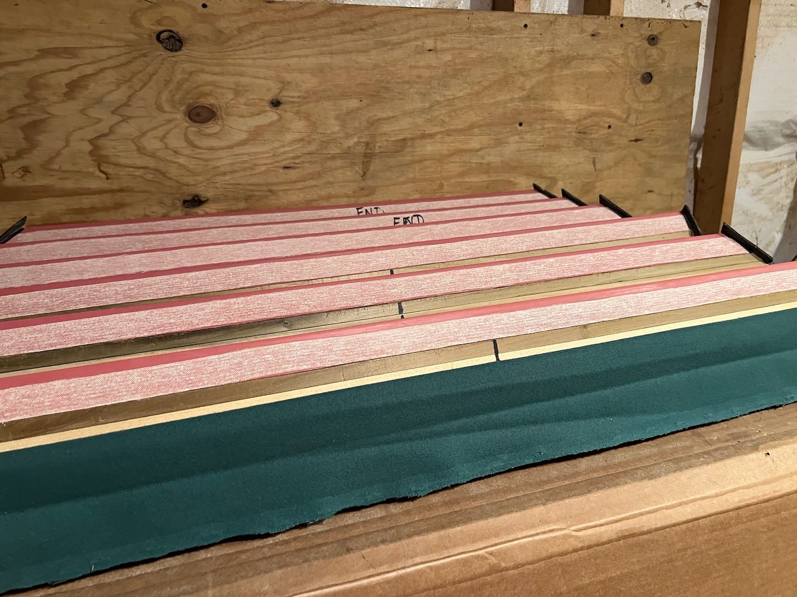 A wooden box with a striped blanket on top of it.