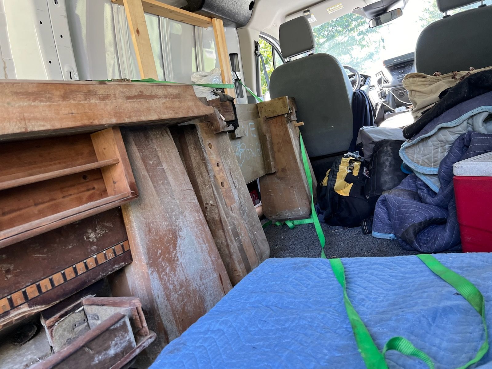 The inside of a van filled with lots of junk.