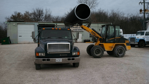 Construction - Skid Steer Loader holding a Concrete drainage pipes in Libertyville, IL
