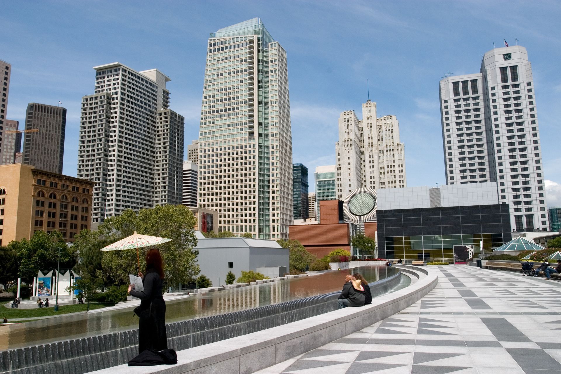 A woman stands in front of a city skyline
