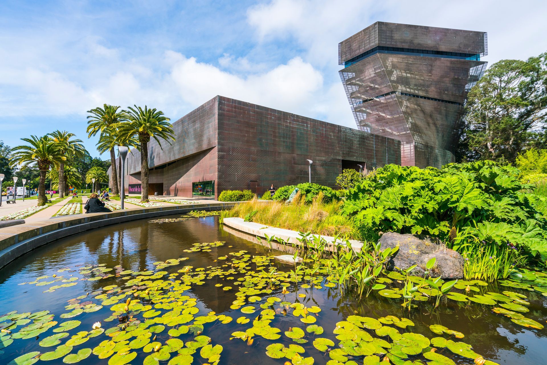 A large building with a pond in front of it.