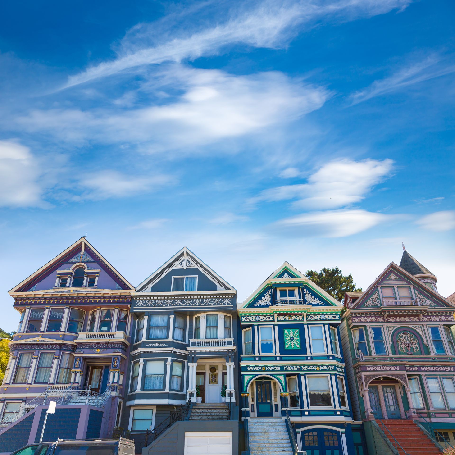 A row of houses with a blue sky in the background