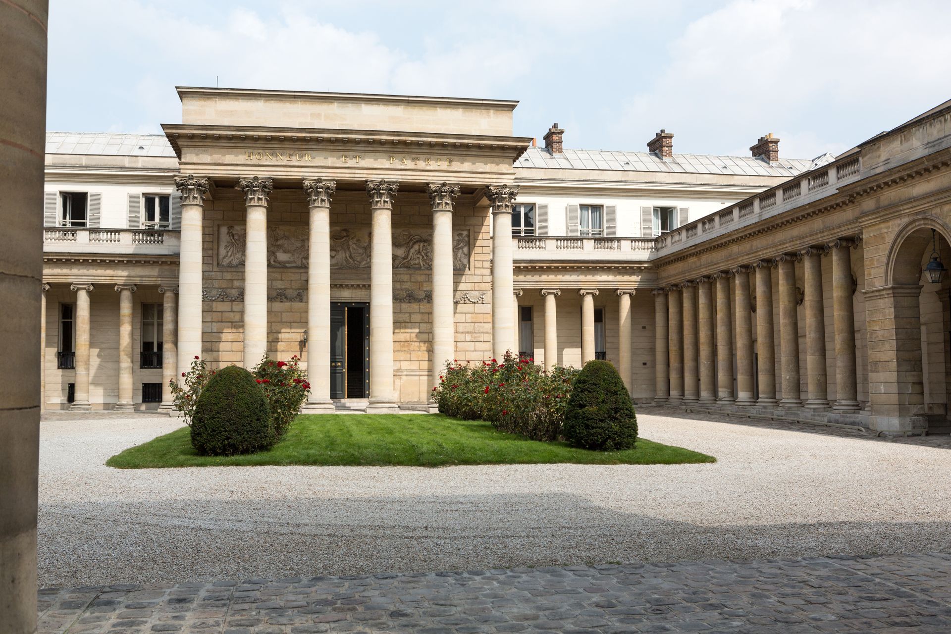 A large building with columns and a courtyard in front of it