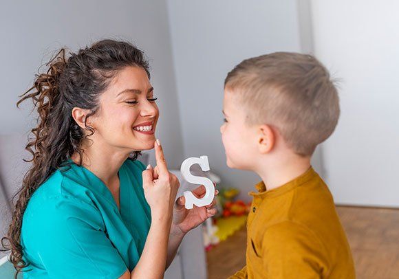 Speech Therapist and Boy — Babylon, NY — South Shore Speech, Language & Swallowing Disorders, PLLC
