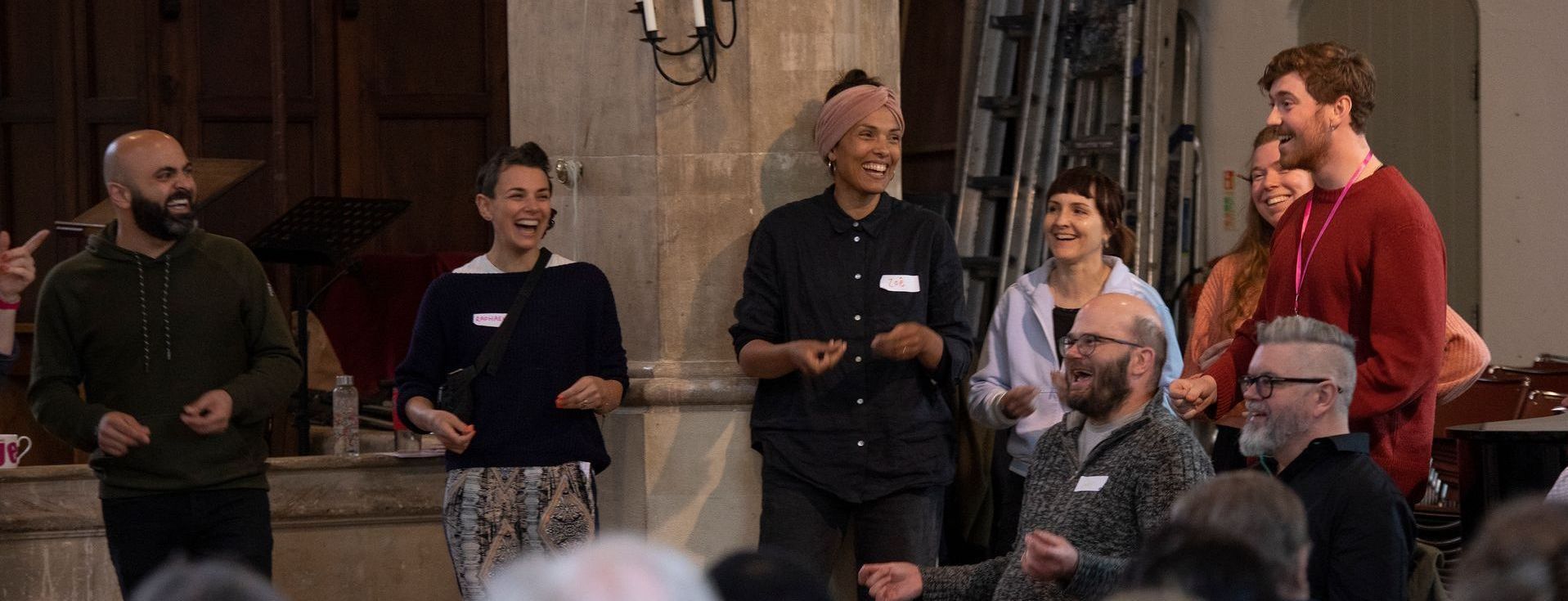 A group of people are standing in front of a crowd.